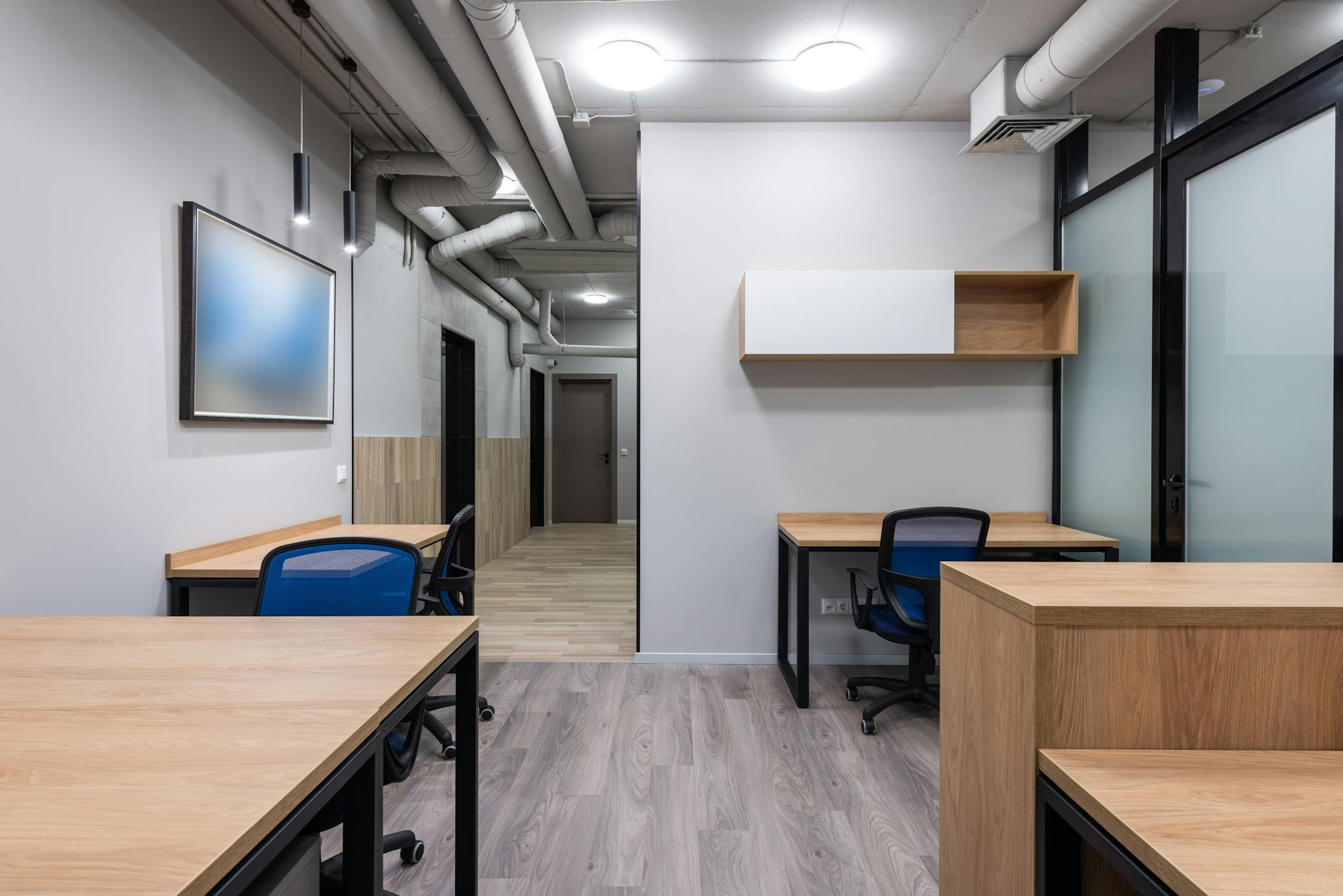 Contemporary office interior with minimalist design and wooden furniture.